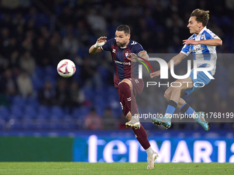 Alex Petxarroman of RC Deportivo de La Coruna competes for the ball with Antonio Puertas of SD Eibar during the LaLiga Hypermotion match bet...