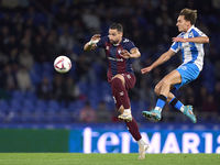 Alex Petxarroman of RC Deportivo de La Coruna competes for the ball with Antonio Puertas of SD Eibar during the LaLiga Hypermotion match bet...