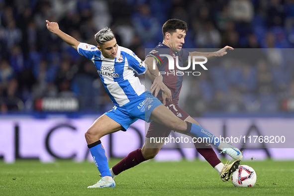 Xeber Alkain of SD Eibar competes for the ball with Yeremay Hernandez of RC Deportivo de La Coruna during the LaLiga Hypermotion match betwe...