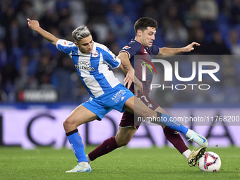 Xeber Alkain of SD Eibar competes for the ball with Yeremay Hernandez of RC Deportivo de La Coruna during the LaLiga Hypermotion match betwe...