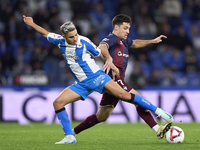 Xeber Alkain of SD Eibar competes for the ball with Yeremay Hernandez of RC Deportivo de La Coruna during the LaLiga Hypermotion match betwe...