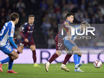 Xeber Alkain of SD Eibar competes for the ball with Yeremay Hernandez of RC Deportivo de La Coruna during the LaLiga Hypermotion match betwe...