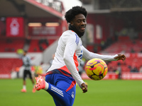 Ola Aina of Nottingham Forest warms up ahead of kick-off during the Premier League match between Nottingham Forest and Newcastle United at t...