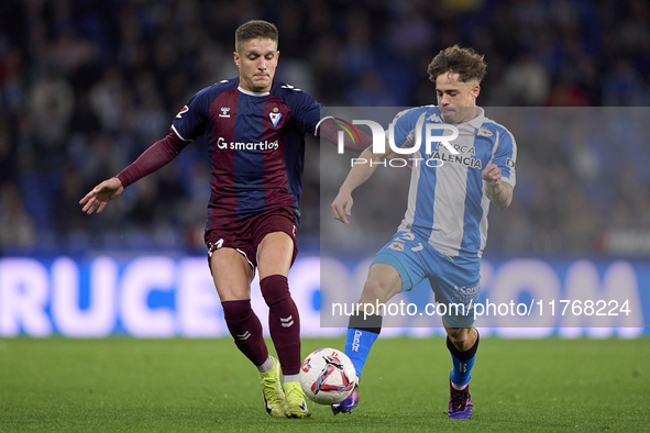 Jose Corpas of SD Eibar competes for the ball with Mario Soriano of RC Deportivo de La Coruna during the LaLiga Hypermotion match between RC...