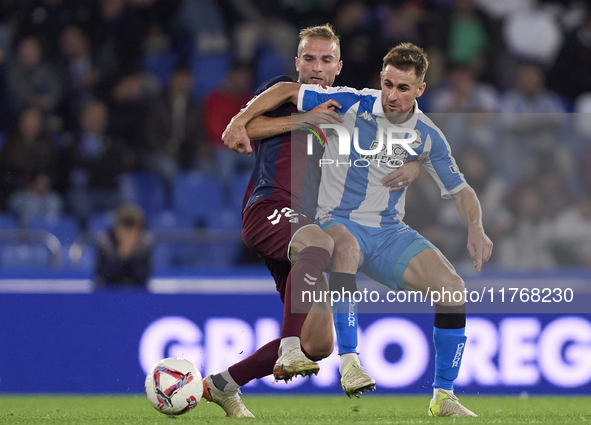 Aritz Arambarri of SD Eibar competes for the ball with Ivan Barbero of RC Deportivo de La Coruna during the LaLiga Hypermotion match between...