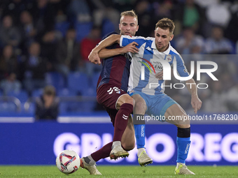 Aritz Arambarri of SD Eibar competes for the ball with Ivan Barbero of RC Deportivo de La Coruna during the LaLiga Hypermotion match between...