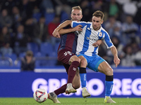 Aritz Arambarri of SD Eibar competes for the ball with Ivan Barbero of RC Deportivo de La Coruna during the LaLiga Hypermotion match between...