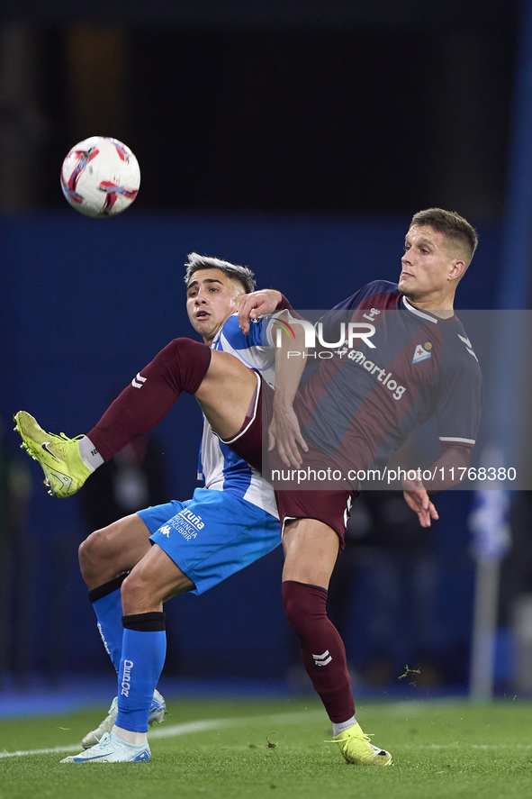 Jose Corpas of SD Eibar competes for the ball with Yeremay Hernandez of RC Deportivo de La Coruna during the LaLiga Hypermotion match betwee...