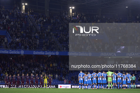 Players of RC Deportivo de La Coruna and players of SD Eibar observe a minute's silence in support of the Valencia flooding victims prior to...