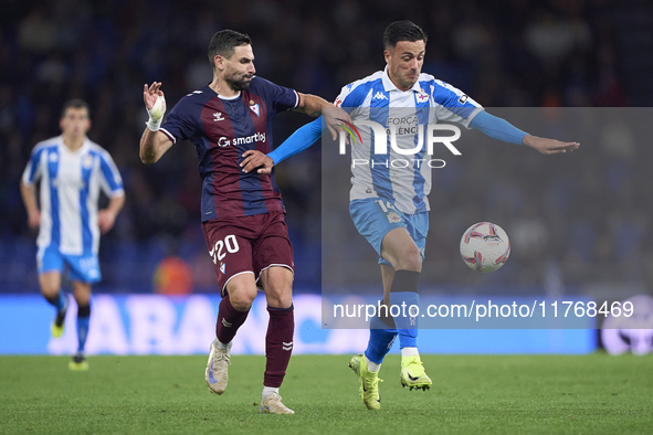 Antonio Puertas of SD Eibar competes for the ball with Cristian Herrera of RC Deportivo de La Coruna during the LaLiga Hypermotion match bet...