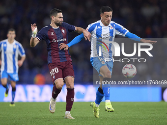 Antonio Puertas of SD Eibar competes for the ball with Cristian Herrera of RC Deportivo de La Coruna during the LaLiga Hypermotion match bet...