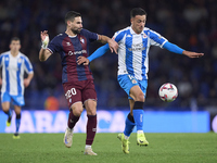 Antonio Puertas of SD Eibar competes for the ball with Cristian Herrera of RC Deportivo de La Coruna during the LaLiga Hypermotion match bet...