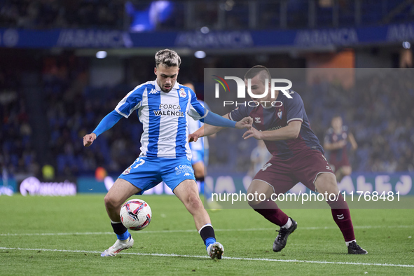 Hodei Arrillaga of SD Eibar competes for the ball with David Mella of RC Deportivo de La Coruna during the LaLiga Hypermotion match between...