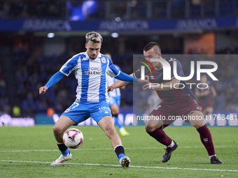 Hodei Arrillaga of SD Eibar competes for the ball with David Mella of RC Deportivo de La Coruna during the LaLiga Hypermotion match between...