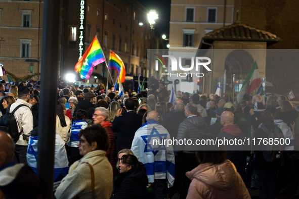 People hold Israeli flags as they attend a demonstration against anti-Semitic violence at Largo Argentina in Rome, Italy, on November 11, 20...