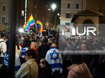 People hold Israeli flags as they attend a demonstration against anti-Semitic violence at Largo Argentina in Rome, Italy, on November 11, 20...