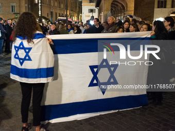 People hold Israeli flags as they attend a demonstration against anti-Semitic violence at Largo Argentina in Rome, Italy, on November 11, 20...