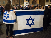 People hold Israeli flags as they attend a demonstration against anti-Semitic violence at Largo Argentina in Rome, Italy, on November 11, 20...