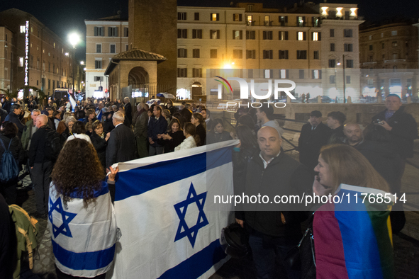 People hold Israeli flags as they attend a demonstration against anti-Semitic violence at Largo Argentina in Rome, Italy, on November 11, 20...