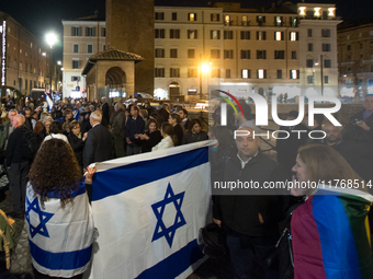 People hold Israeli flags as they attend a demonstration against anti-Semitic violence at Largo Argentina in Rome, Italy, on November 11, 20...