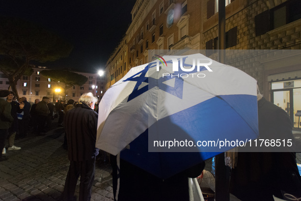 People hold Israeli flags as they attend a demonstration against anti-Semitic violence at Largo Argentina in Rome, Italy, on November 11, 20...