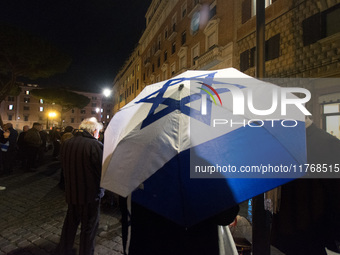 People hold Israeli flags as they attend a demonstration against anti-Semitic violence at Largo Argentina in Rome, Italy, on November 11, 20...