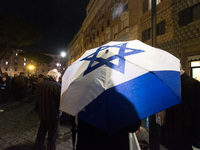 People hold Israeli flags as they attend a demonstration against anti-Semitic violence at Largo Argentina in Rome, Italy, on November 11, 20...