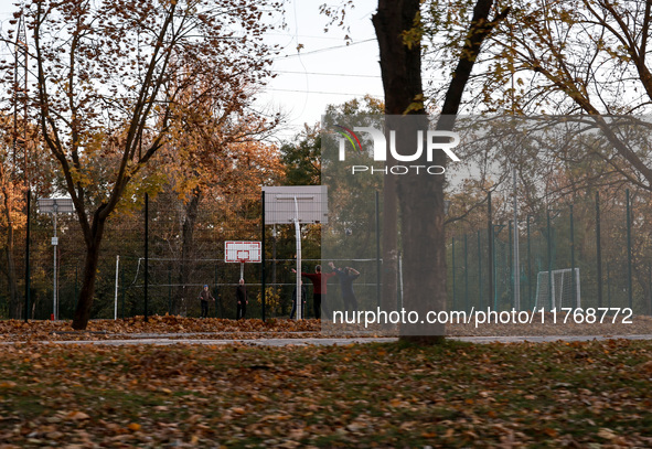 Men play basketball on the sports ground in Kherson, Ukraine, on November 7, 2024. 