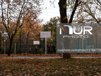 Men play basketball on the sports ground in Kherson, Ukraine, on November 7, 2024. (