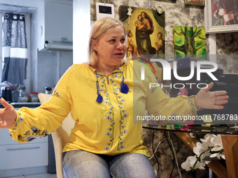 A local resident, Svitlana, wears a vyshyvanka as she speaks with journalists in Kherson, Ukraine, on November 7, 2024. (