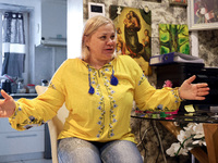 A local resident, Svitlana, wears a vyshyvanka as she speaks with journalists in Kherson, Ukraine, on November 7, 2024. (