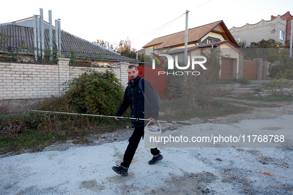 A local resident heads towards the river with fishing gear in Kherson, Ukraine, on November 7, 2024. 