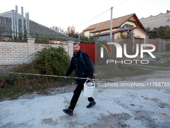 A local resident heads towards the river with fishing gear in Kherson, Ukraine, on November 7, 2024. (