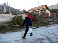 A local resident heads towards the river with fishing gear in Kherson, Ukraine, on November 7, 2024. (