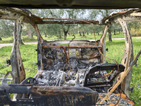 A burnt and abandoned stolen car rests in the rural fields near Cerignola, Italy, on October 4, 2024. The vehicle, stripped of all valuables...