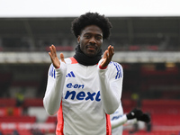 Ola Aina of Nottingham Forest warms up ahead of kick-off during the Premier League match between Nottingham Forest and Newcastle United at t...