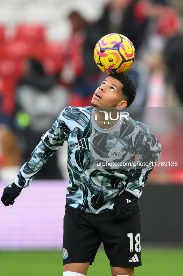 William Osula of Newcastle United balances the ball during the Premier League match between Nottingham Forest and Newcastle United at the Ci...