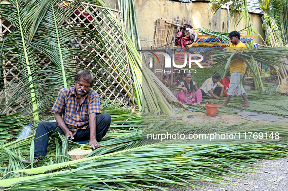 A man cuts coconut leaves for the preparation of a traditional decorative background for the upcoming wedding season at a street side in Hyd...