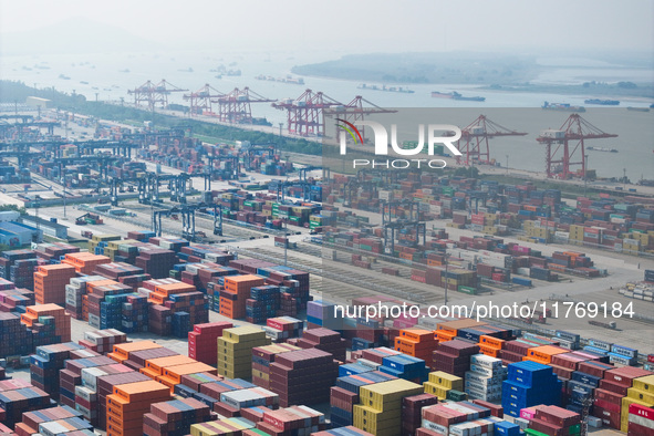 Cargo ships load and unload at berths, and trucks shuttle in the yard at Longtan Port area of Nanjing Port in Nanjing, Jiangsu province, Chi...