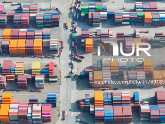 Cargo ships load and unload at berths, and trucks shuttle in the yard at Longtan Port area of Nanjing Port in Nanjing, Jiangsu province, Chi...