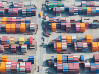 Cargo ships load and unload at berths, and trucks shuttle in the yard at Longtan Port area of Nanjing Port in Nanjing, Jiangsu province, Chi...