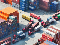 Cargo ships load and unload at berths, and trucks shuttle in the yard at Longtan Port area of Nanjing Port in Nanjing, Jiangsu province, Chi...