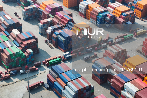 Cargo ships load and unload at berths, and trucks shuttle in the yard at Longtan Port area of Nanjing Port in Nanjing, Jiangsu province, Chi...