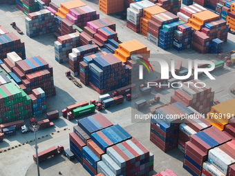 Cargo ships load and unload at berths, and trucks shuttle in the yard at Longtan Port area of Nanjing Port in Nanjing, Jiangsu province, Chi...