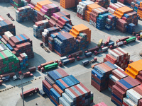 Cargo ships load and unload at berths, and trucks shuttle in the yard at Longtan Port area of Nanjing Port in Nanjing, Jiangsu province, Chi...