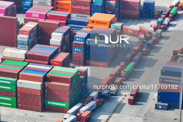 Cargo ships load and unload at berths, and trucks shuttle in the yard at Longtan Port area of Nanjing Port in Nanjing, Jiangsu province, Chi...