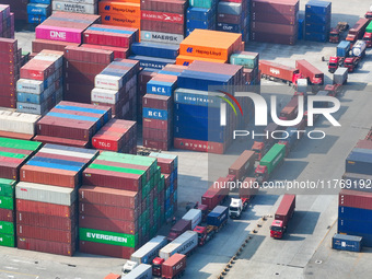 Cargo ships load and unload at berths, and trucks shuttle in the yard at Longtan Port area of Nanjing Port in Nanjing, Jiangsu province, Chi...