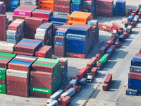 Cargo ships load and unload at berths, and trucks shuttle in the yard at Longtan Port area of Nanjing Port in Nanjing, Jiangsu province, Chi...