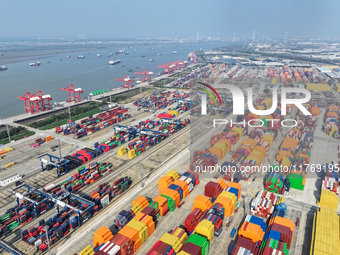 Cargo ships load and unload at berths, and trucks shuttle in the yard at Longtan Port area of Nanjing Port in Nanjing, Jiangsu province, Chi...