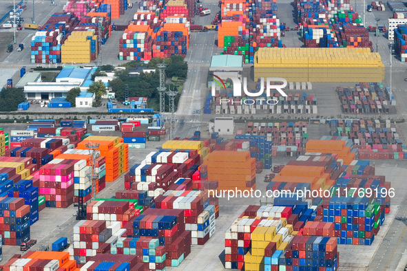 Cargo ships load and unload at berths, and trucks shuttle in the yard at Longtan Port area of Nanjing Port in Nanjing, Jiangsu province, Chi...